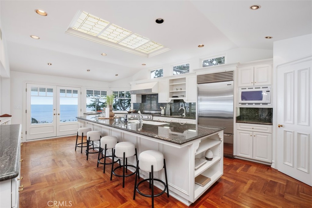 1201 Emerald Bay Laguna Beach, CA 92651 - Photo 18 of 47 a kitchen with counter top space cabinets and stainless steel appliances