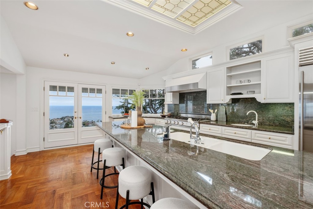 1201 Emerald Bay Laguna Beach, CA 92651 - Photo 19 of 47 a kitchen with stainless steel appliances granite countertop a sink and cabinets