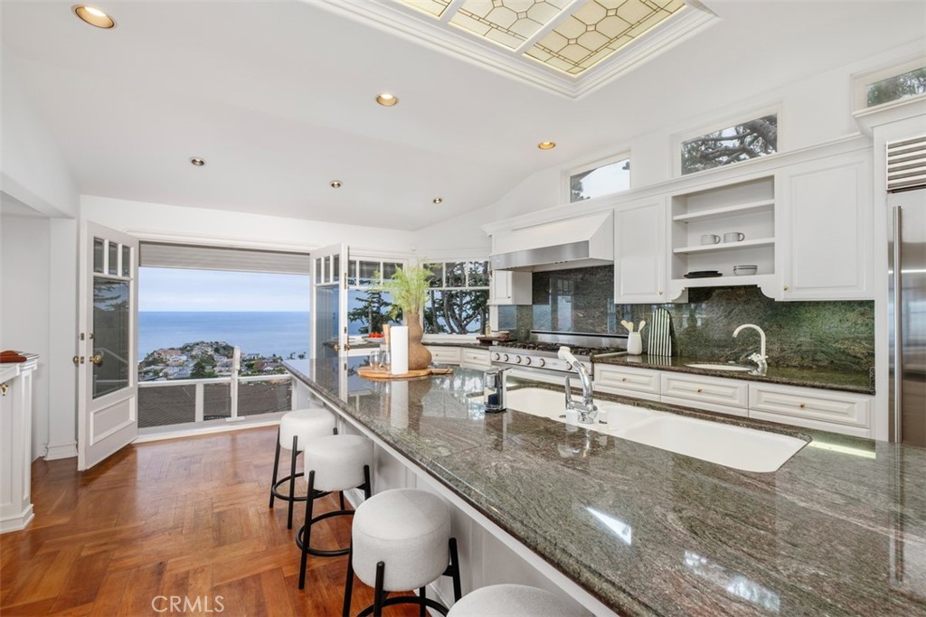 1201 Emerald Bay Laguna Beach, CA 92651 - Photo 20 of 47 a kitchen with stainless steel appliances granite countertop a sink and cabinets
