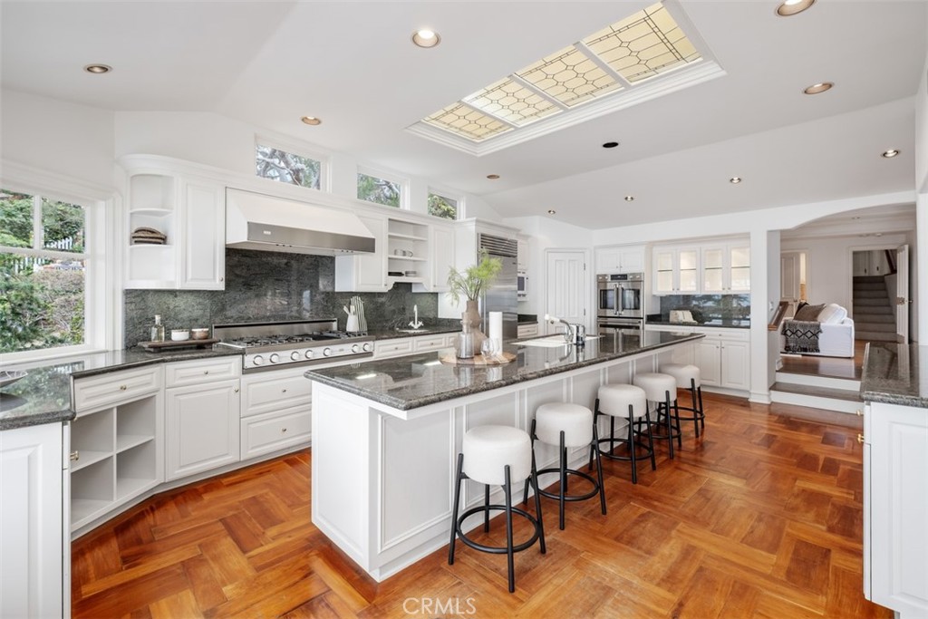 1201 Emerald Bay Laguna Beach, CA 92651 - Photo 22 of 47 a large white kitchen with lots of counter top space and appliances