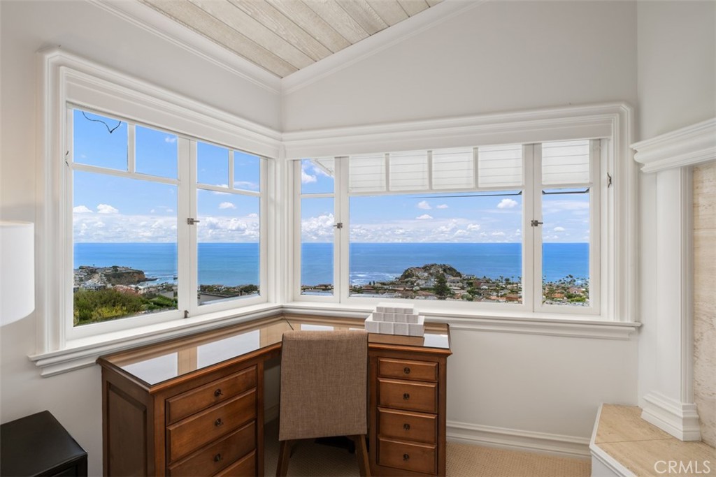 1201 Emerald Bay Laguna Beach, CA 92651 - Photo 31 of 47 a kitchen with stainless steel appliances kitchen island wooden cabinets and a large window