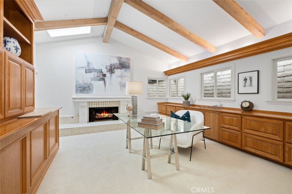 1201 Emerald Bay Laguna Beach, CA 92651 - Photo 37 of 47 a living room with furniture a fireplace and kitchen view