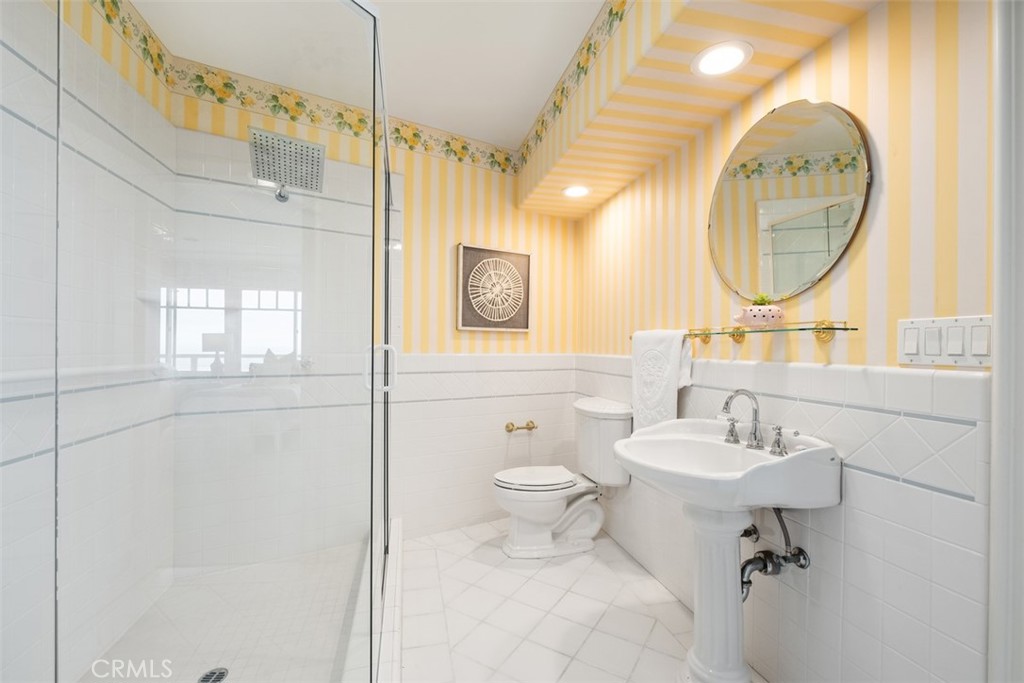 1201 Emerald Bay Laguna Beach, CA 92651 - Photo 41 of 47 a bathroom with a toilet sink and mirror