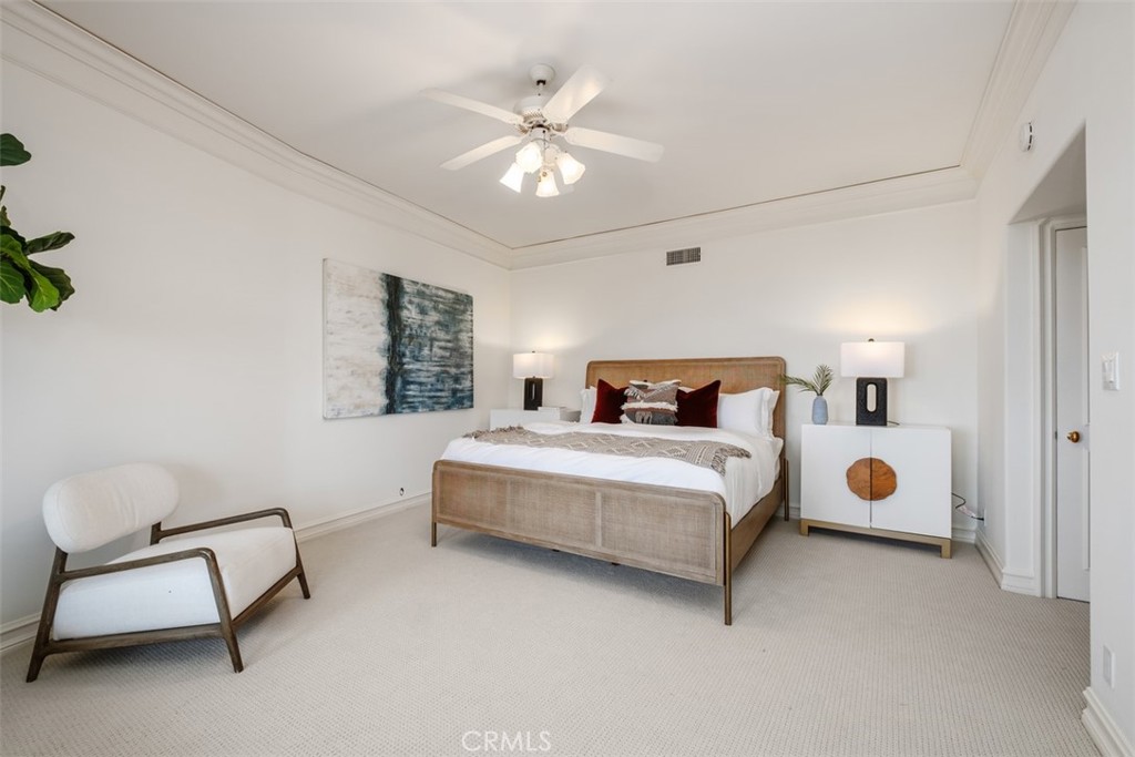 1201 Emerald Bay Laguna Beach, CA 92651 - Photo 42 of 47 a bedroom with a bed and a chandelier