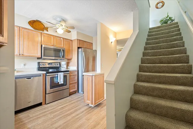 a kitchen with stainless steel appliances a stove microwave and a refrigerator