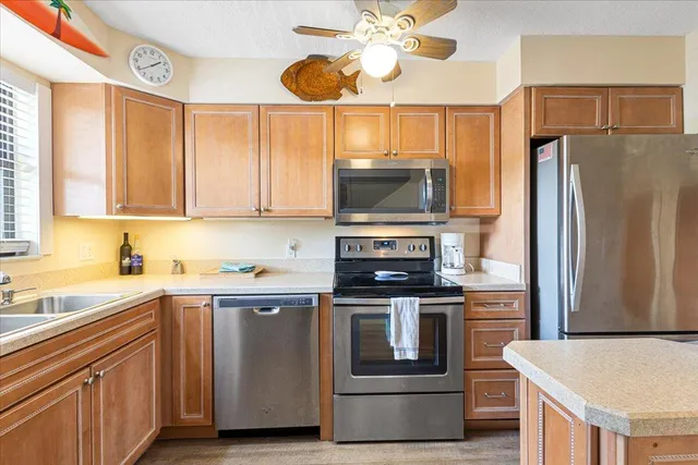 a kitchen with stainless steel appliances granite countertop a sink stove and cabinets