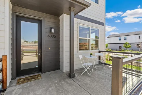 a view of an outdoor dining space with a couple of chairs