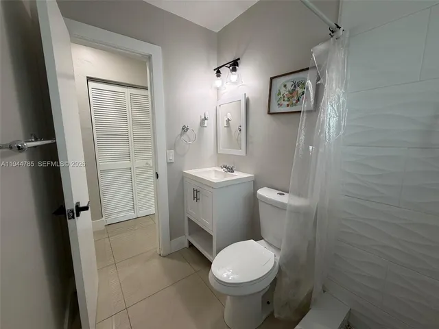 a bathroom with a shower toilet and sink