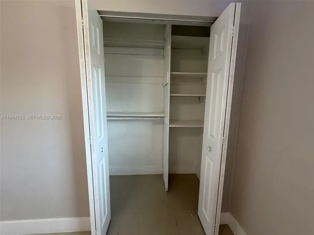 a white toilet sitting next to a bathtub