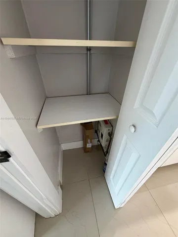 a kitchen with granite countertop a sink a stove and cabinets