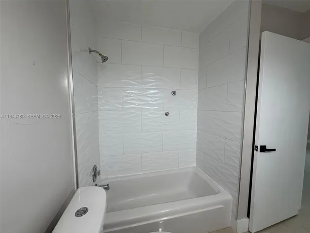 a view of a porch with furniture potted plants and large tree