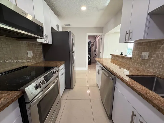 a view of house with outdoor space and trees