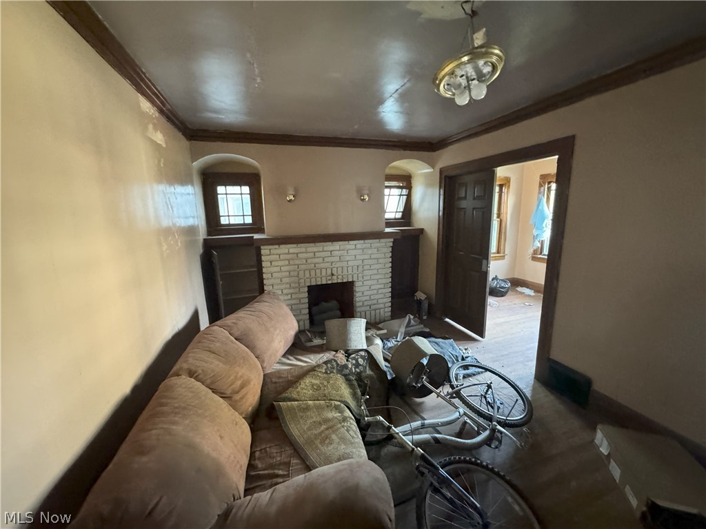 971 Helmsdale Road Cleveland Heights, OH 44112 - Photo 2 of 19 Living room featuring ornamental molding and a fireplace