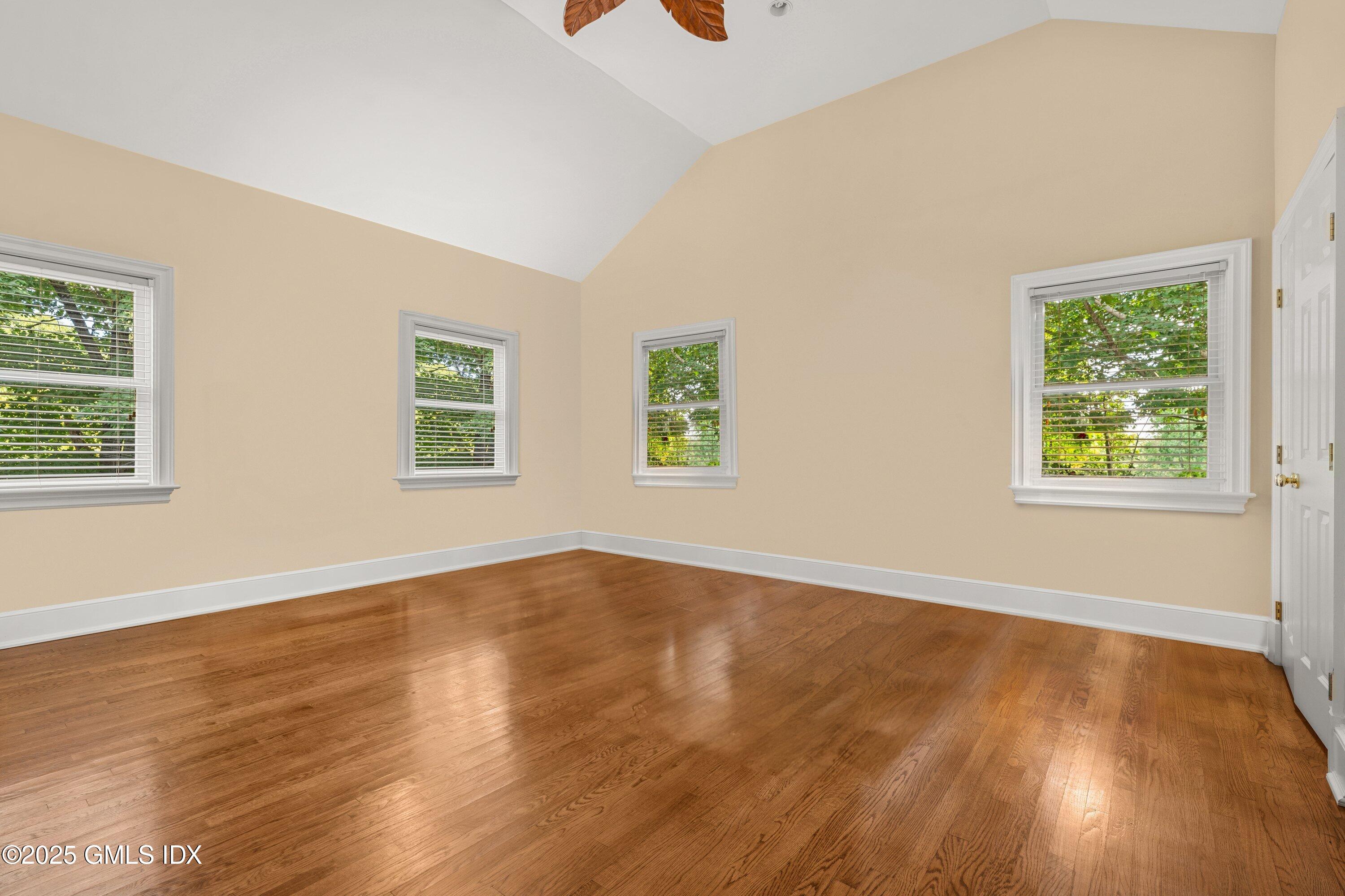 176 Valley Road Cos Cob, CT 06807 - Photo 17 of 27 a view of an empty room with wooden floor and a window