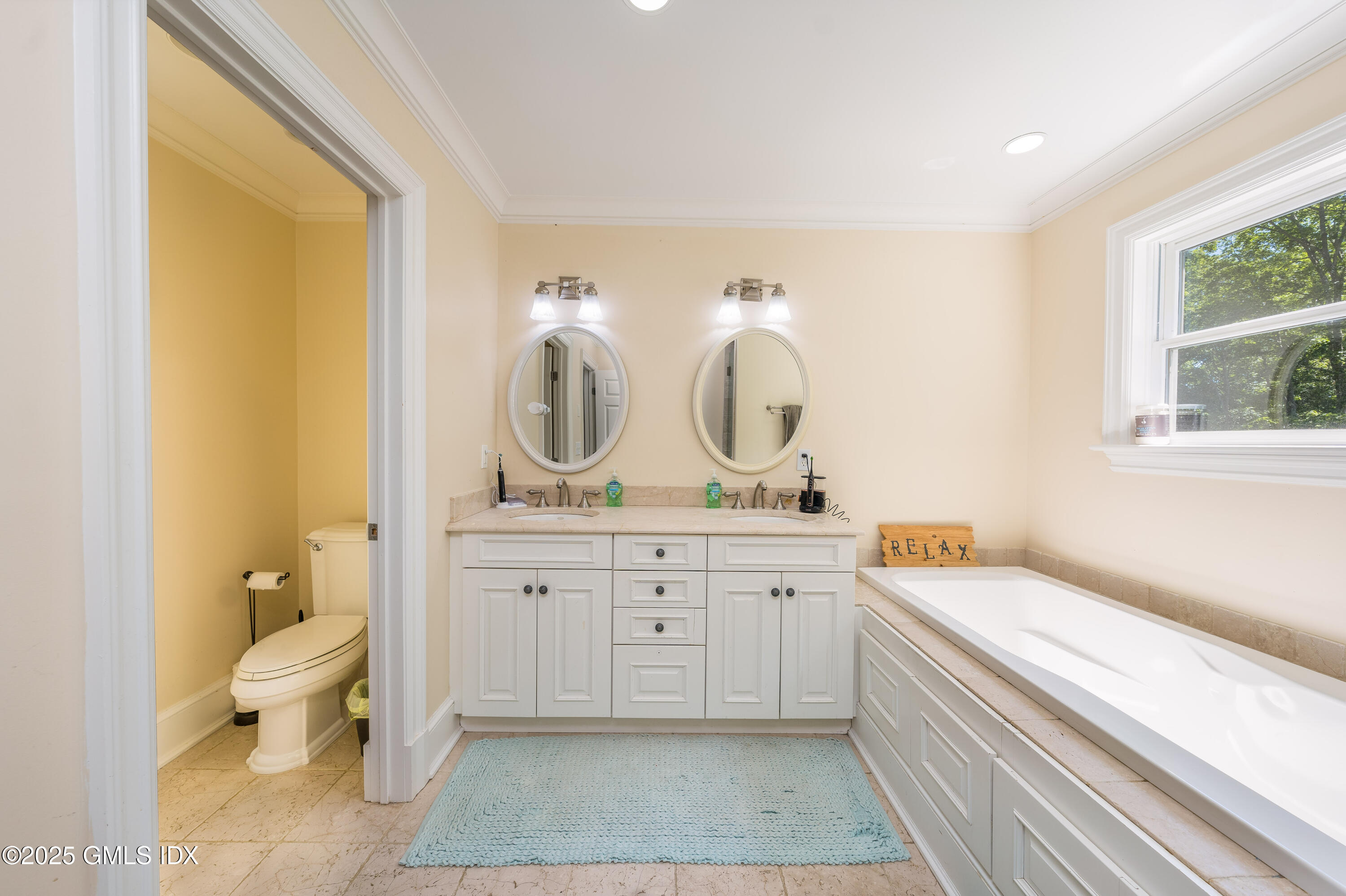 176 Valley Road Cos Cob, CT 06807 - Photo 18 of 27 a spacious bathroom with a granite countertop sink and a mirror