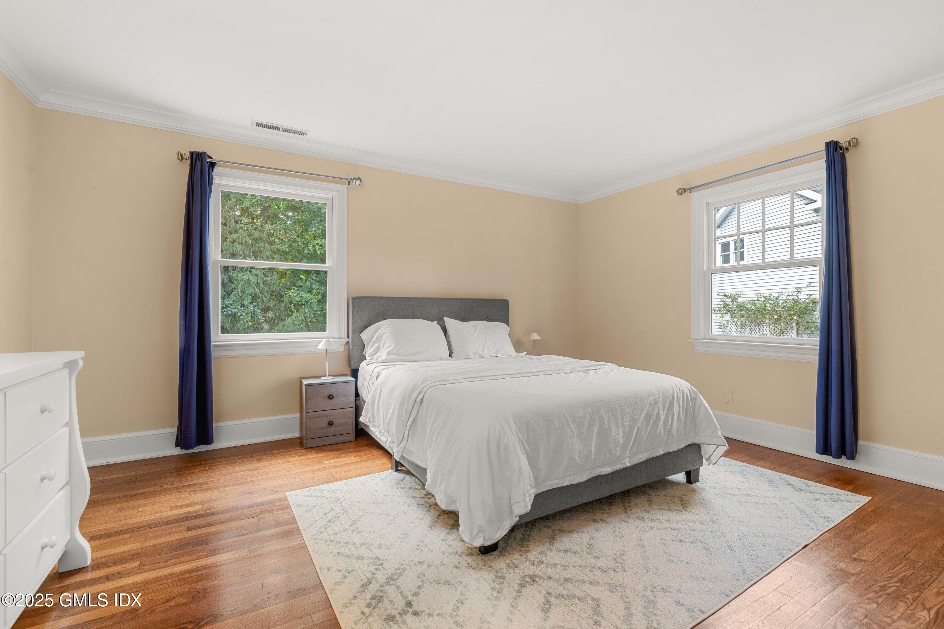 176 Valley Road Cos Cob, CT 06807 - Photo 20 of 27 a bedroom with a large bed and a window