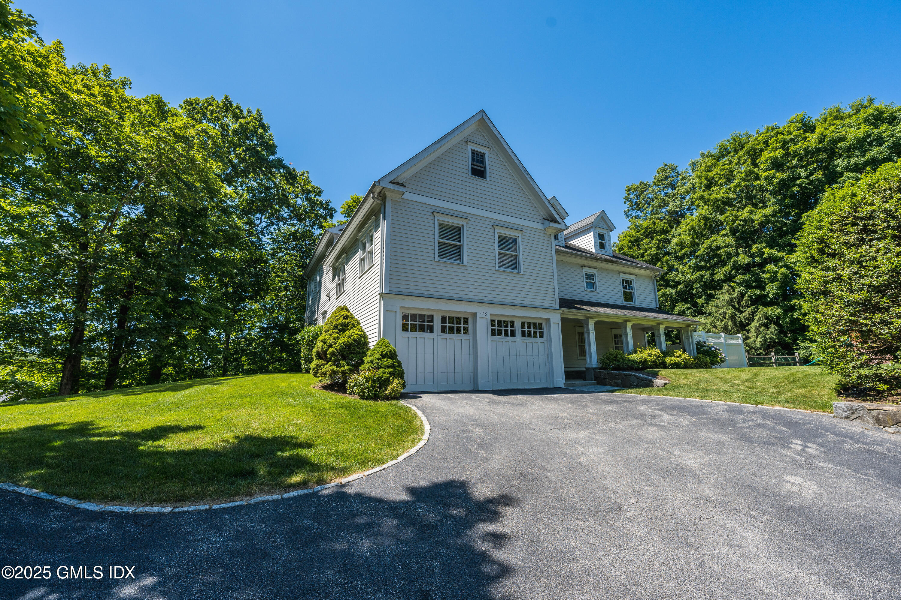 176 Valley Road Cos Cob, CT 06807 - Photo 2 of 27 a view of a house with a backyard porch and garden