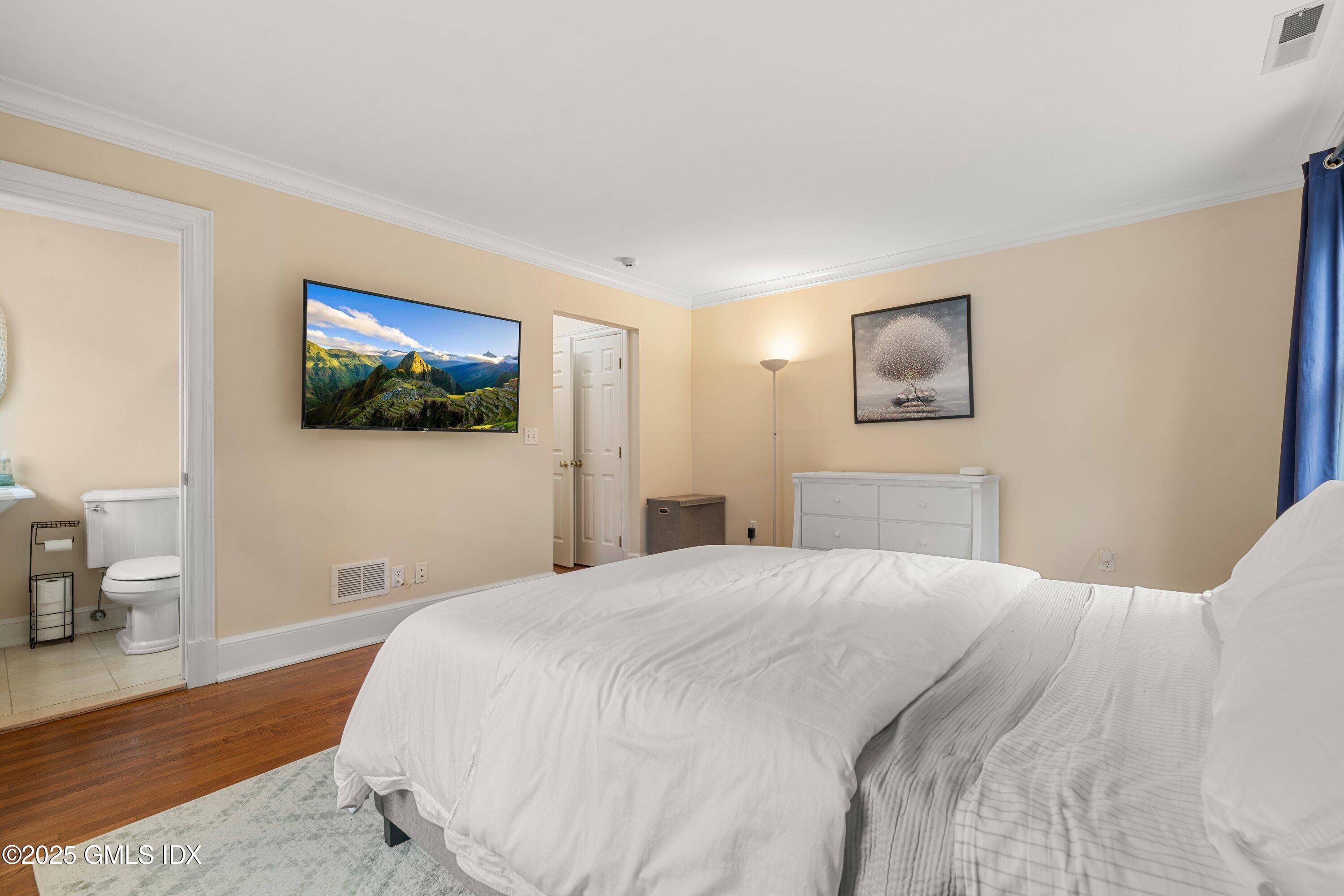176 Valley Road Cos Cob, CT 06807 - Photo 21 of 27 a bedroom with a bed and a flat screen tv