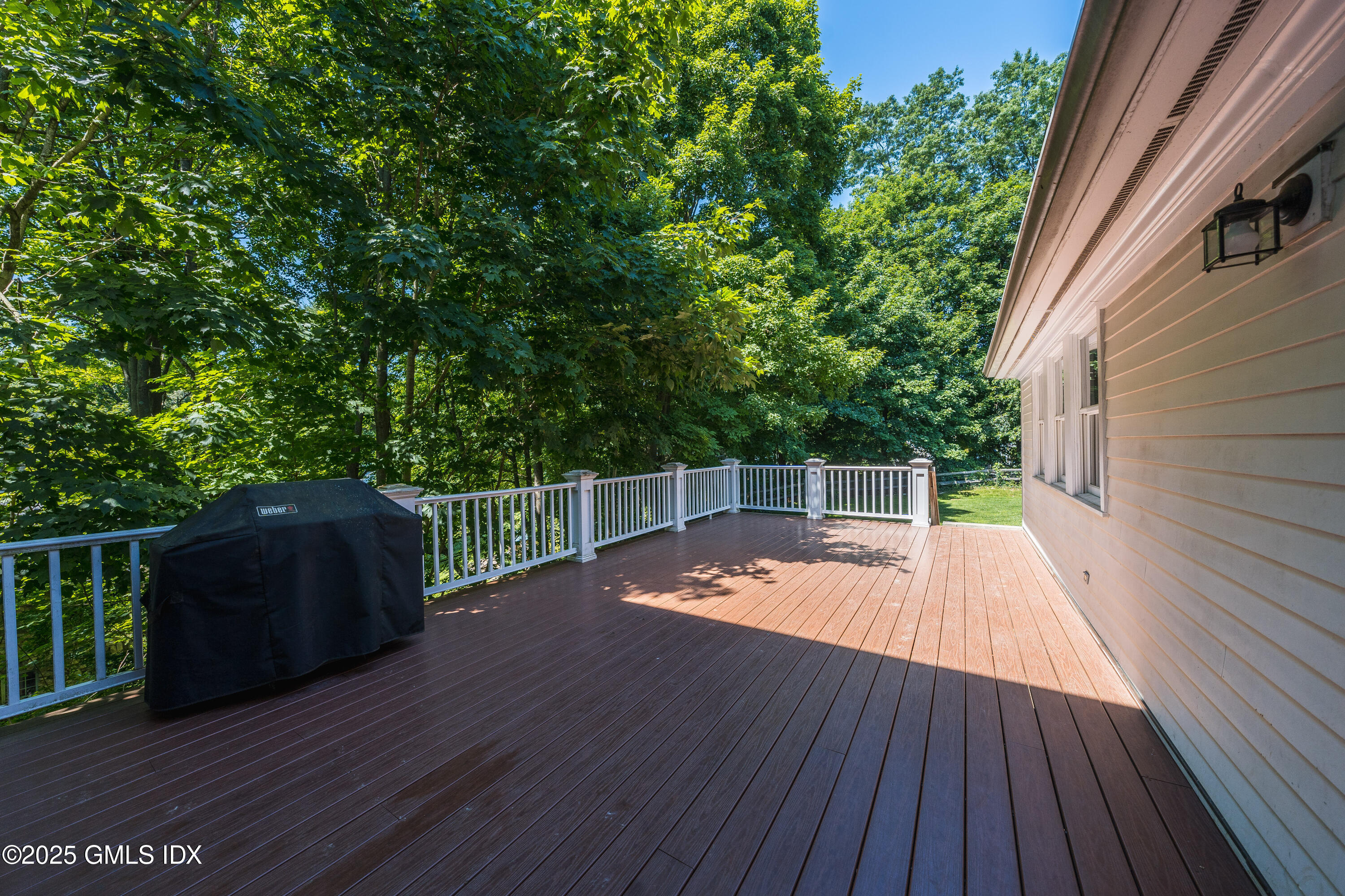 176 Valley Road Cos Cob, CT 06807 - Photo 26 of 27 a view of a deck with wooden floor and fence