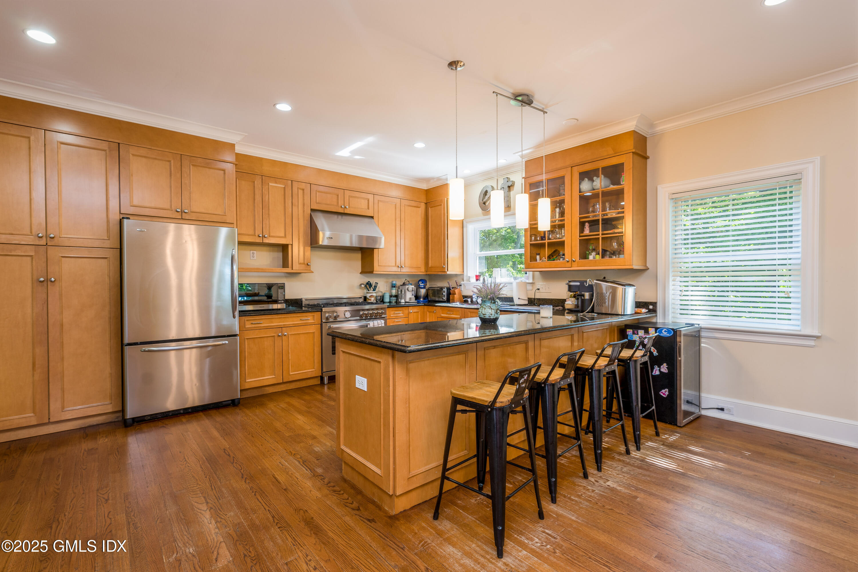 176 Valley Road Cos Cob, CT 06807 - Photo 7 of 27 a kitchen with stainless steel appliances granite countertop a refrigerator a stove a sink a dining table and chairs with wooden floor
