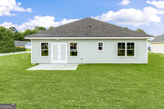 a kitchen with white cabinets and wooden floor