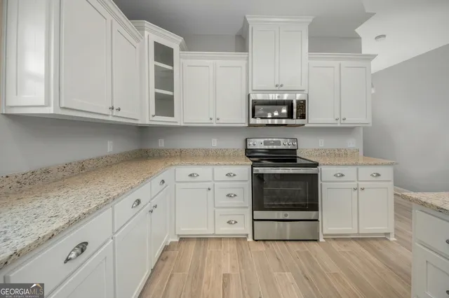 a kitchen with a sink stainless steel appliances and cabinets