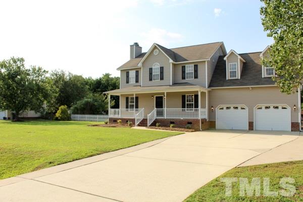 1504 Harvey Johnson Road Raleigh, NC 27603 - Photo 2 of 22 a front view of a house with a garden and patio