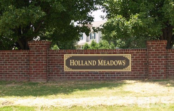 1504 Harvey Johnson Road Raleigh, NC 27603 - Photo 12 of 22 a sign that is on a brick wall