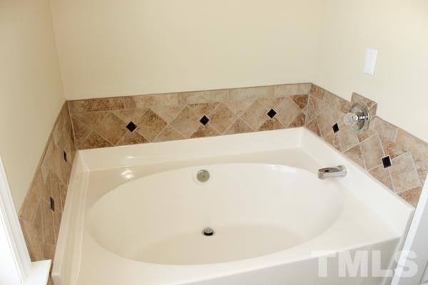 1504 Harvey Johnson Road Raleigh, NC 27603 - Photo 14 of 22 a bathroom with a tub