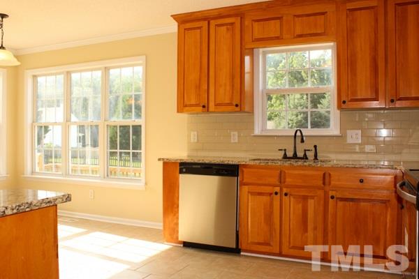 1504 Harvey Johnson Road Raleigh, NC 27603 - Photo 19 of 22 a kitchen with stainless steel appliances granite countertop a sink and a large window