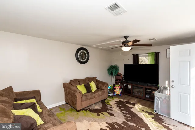 a view of a hallway to a livingroom with furniture