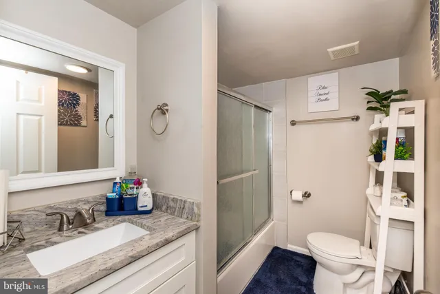 a bathroom with a shower toilet and sink