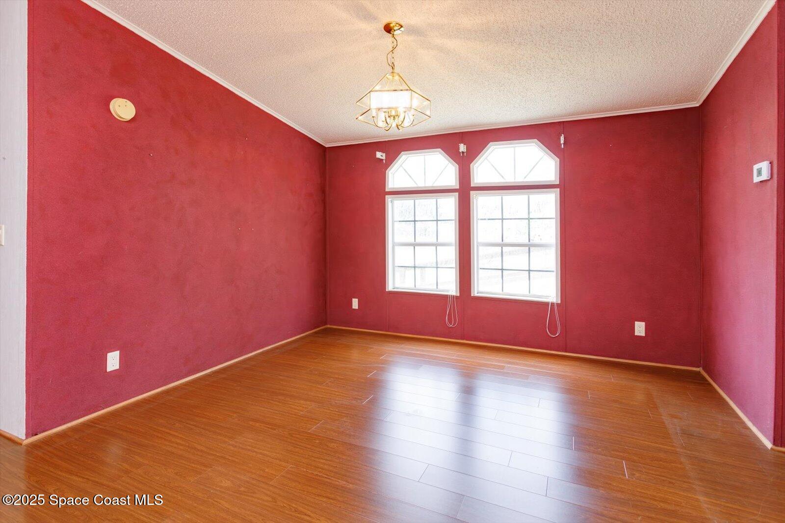 616 Camp Road Cocoa, FL 32927 - Photo 12 of 25 a big room with wooden floor and windows