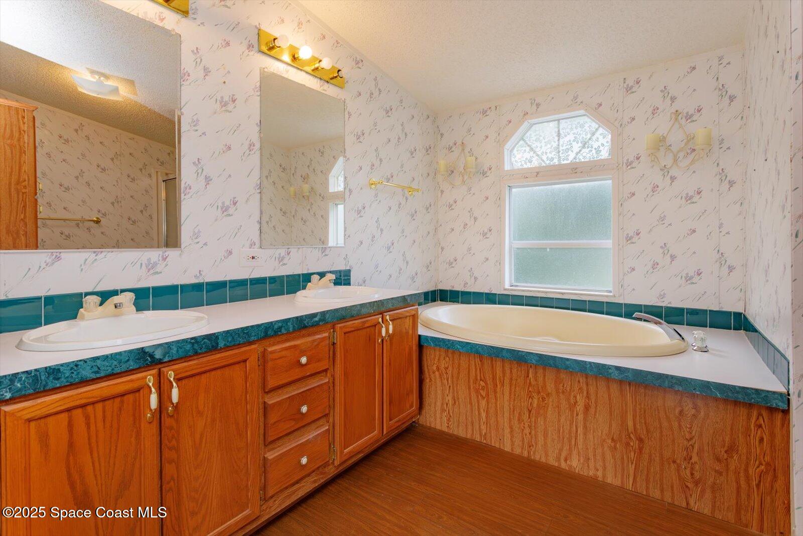 616 Camp Road Cocoa, FL 32927 - Photo 16 of 25 a bathroom with a sink a mirror and a window