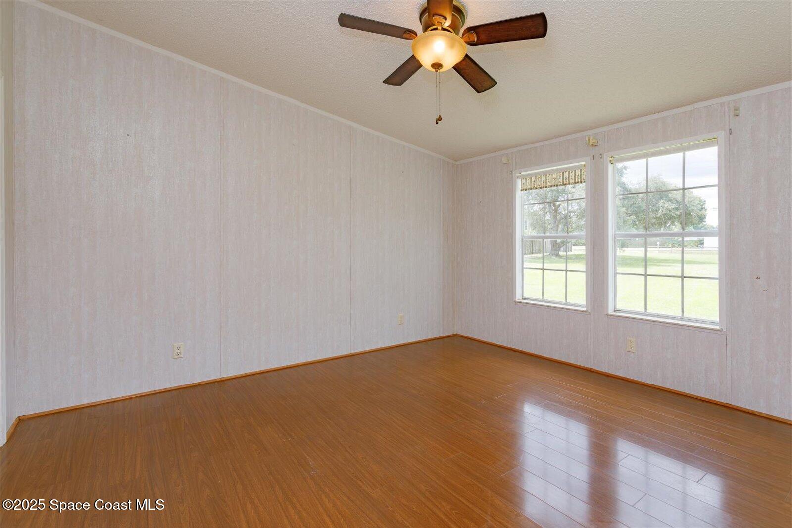 616 Camp Road Cocoa, FL 32927 - Photo 17 of 25 an empty room with a window and a fan