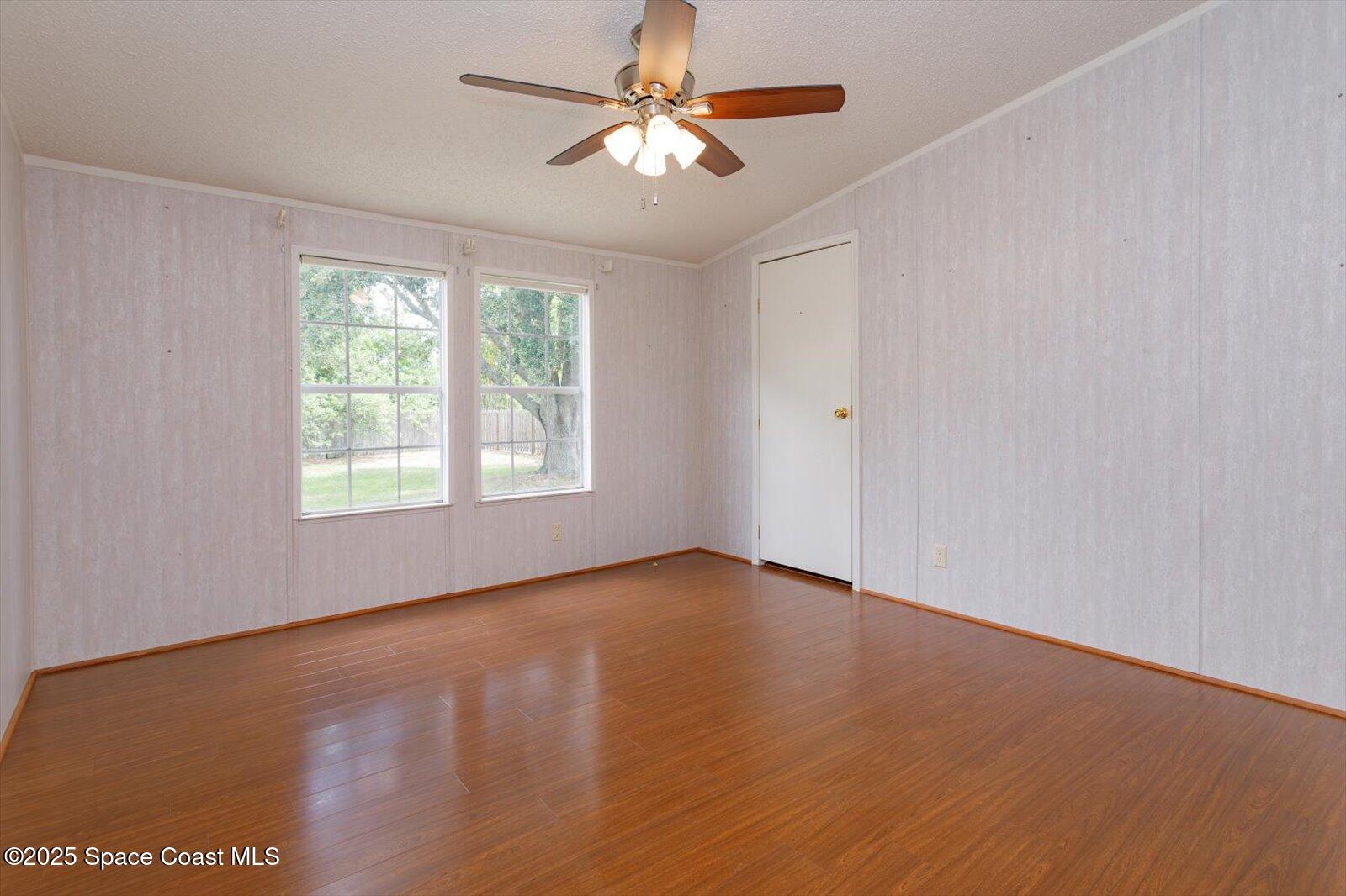616 Camp Road Cocoa, FL 32927 - Photo 19 of 25 a view of an empty room with window and a chandelier fan