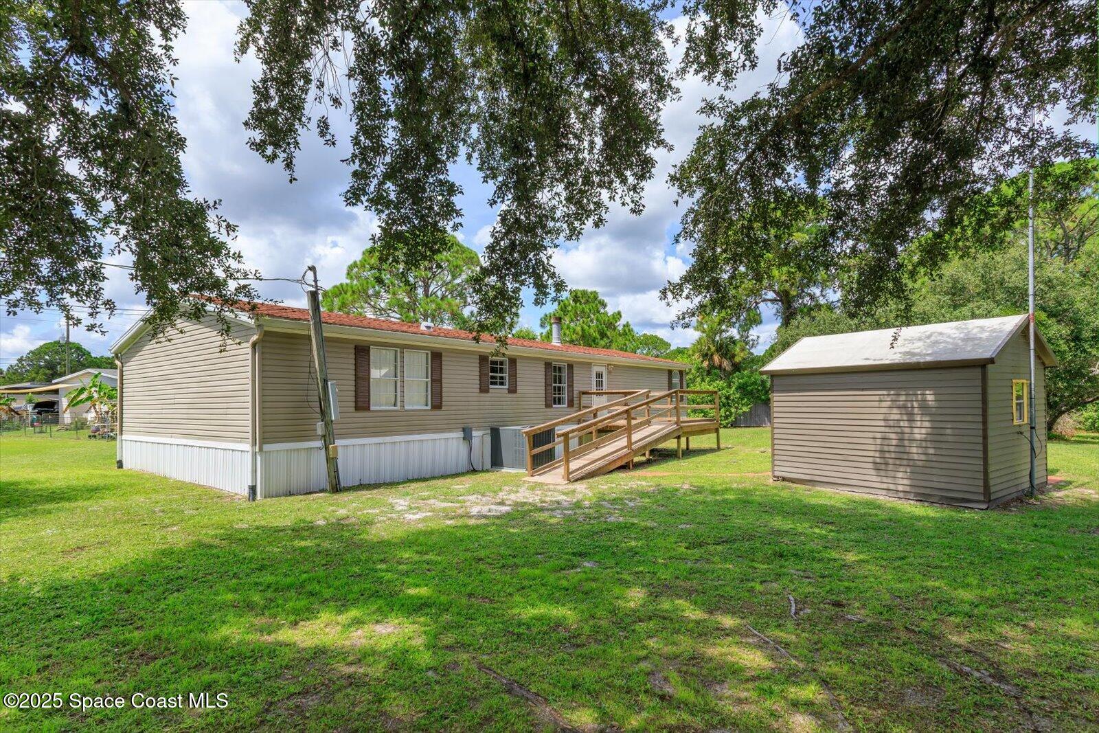 616 Camp Road Cocoa, FL 32927 - Photo 23 of 25 a view of a house with a yard and tree