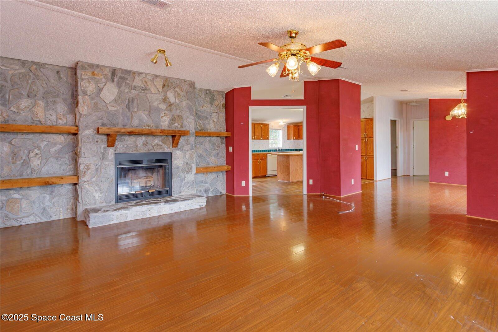 616 Camp Road Cocoa, FL 32927 - Photo 5 of 25 a living room with fireplace furniture and a wooden floor