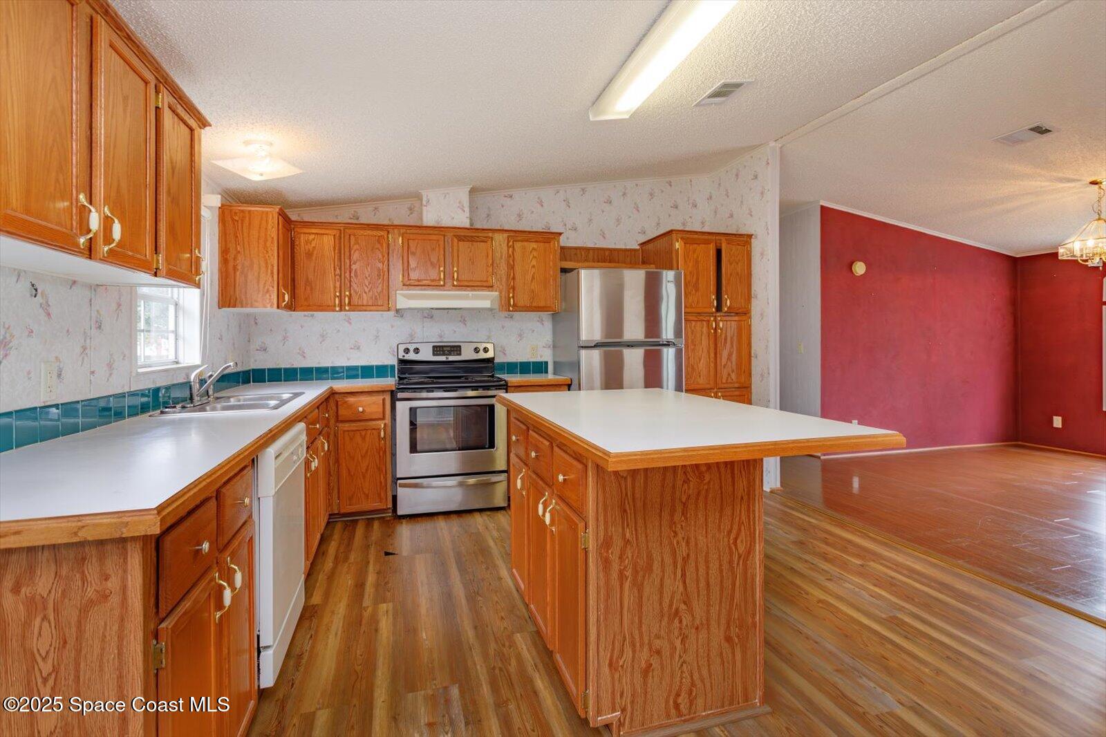 616 Camp Road Cocoa, FL 32927 - Photo 8 of 25 a kitchen with stainless steel appliances a sink a counter top space cabinets and a window