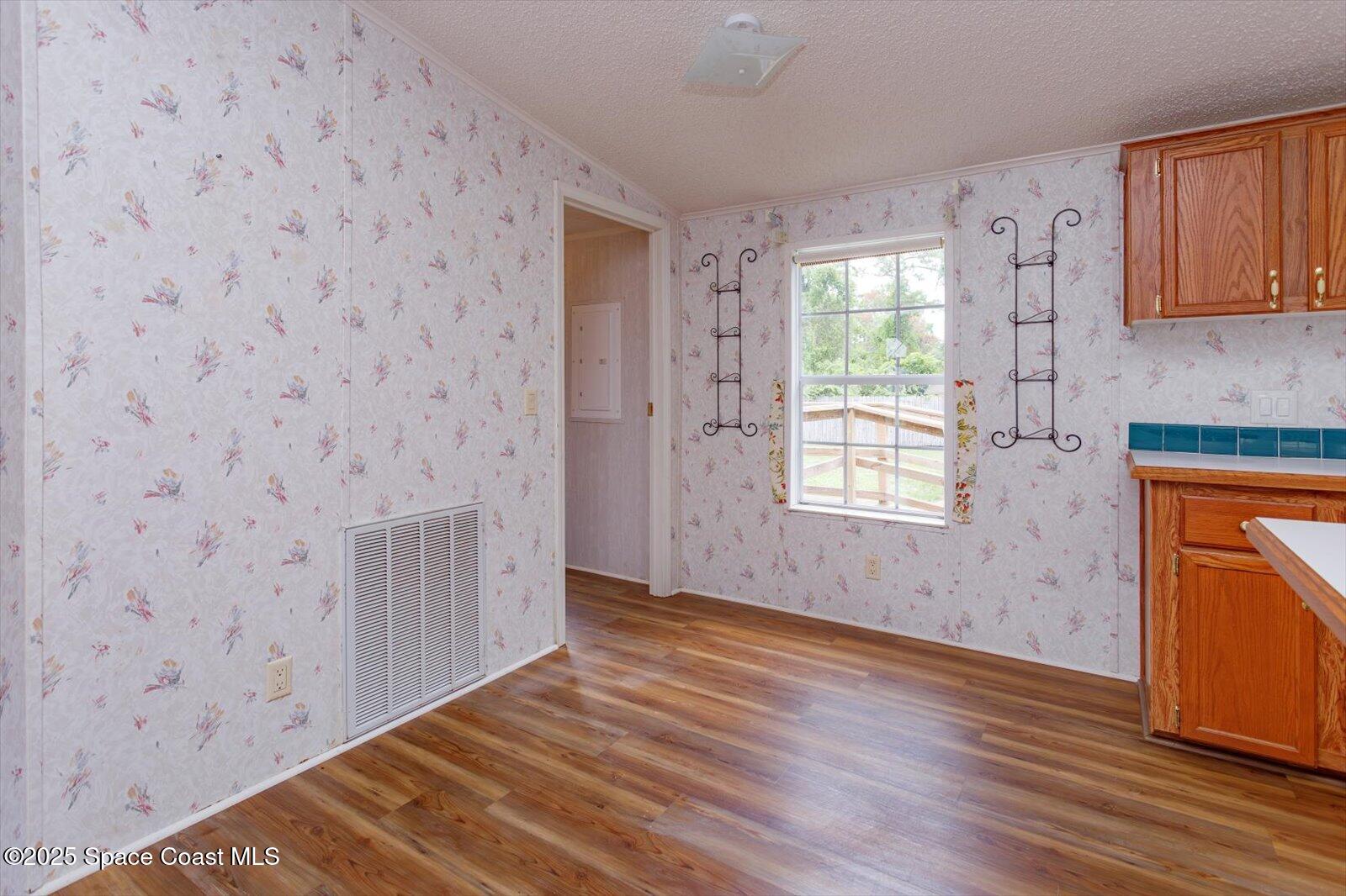 616 Camp Road Cocoa, FL 32927 - Photo 9 of 25 a view of an empty room with wooden floor and a window