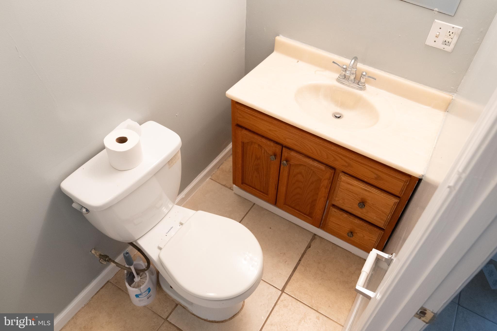 3731 Greenmount Avenue Baltimore, MD 21218 - Photo 18 of 23 a bathroom with a sink mirror vanity and toilet