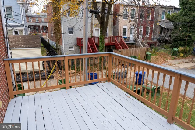 a view of a balcony with wooden floor and city view