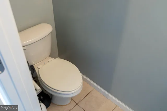 a white toilet sitting next to a white toilet
