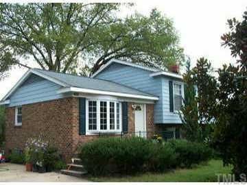 4611 Revere Road Durham, NC 27713 - Photo 1 of 1 a front view of a house with a yard and potted plants