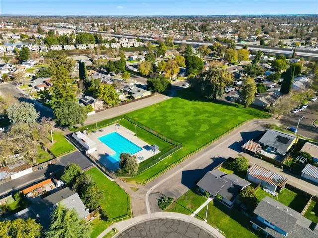 an aerial view of a residential houses with outdoor space
