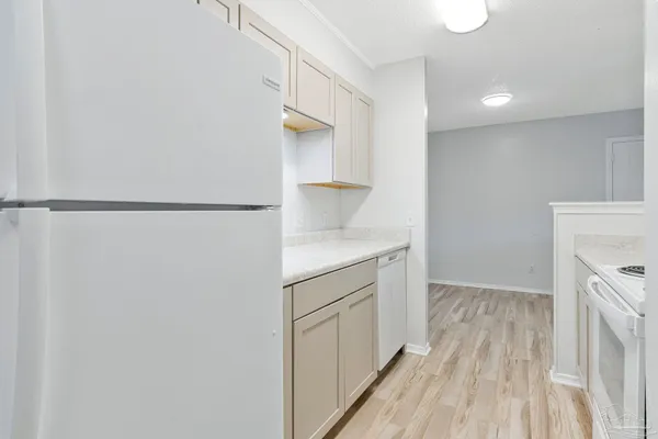 a view of walk in closet with wooden floor