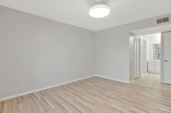 a view of a room with wooden floor and white walls
