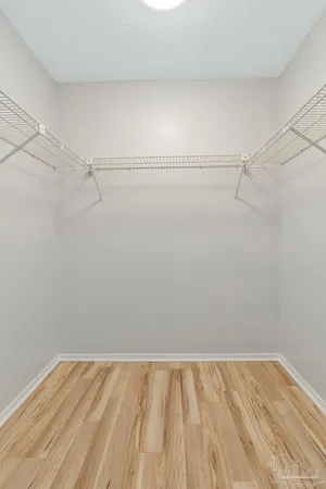 a view of walk in closet with empty racks