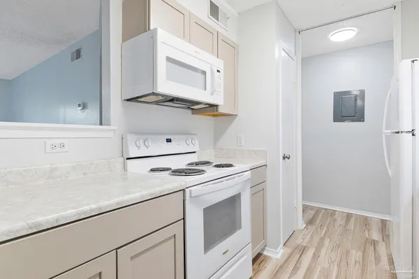 a kitchen with cabinets and appliances