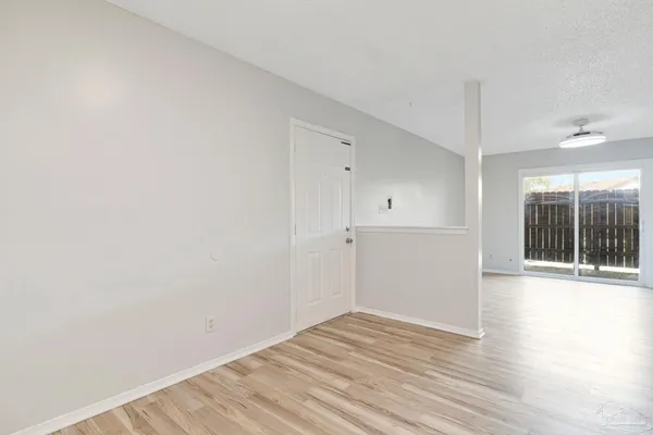 a view of a room with wooden floor and window